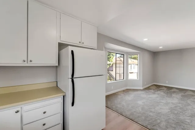 a white refrigerator freezer sitting in a kitchen