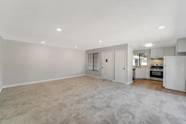 a view of a kitchen and a refrigerator a sink