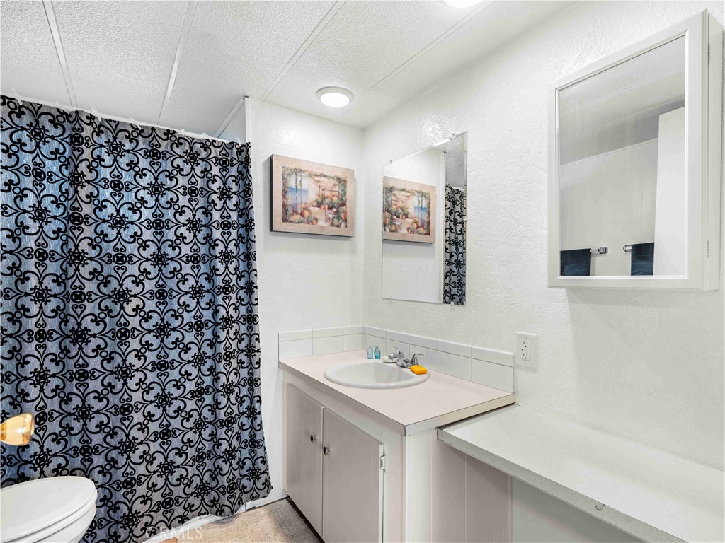11414 Serra Road, Unit 46 Apple Valley, CA 92308 - Photo 13 of 22 a bathroom with a sink and a mirror