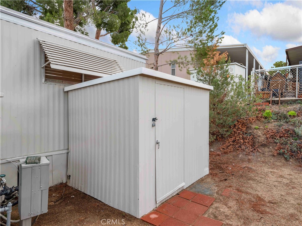 11414 Serra Road, Unit 46 Apple Valley, CA 92308 - Photo 18 of 22 a view of a house with a yard