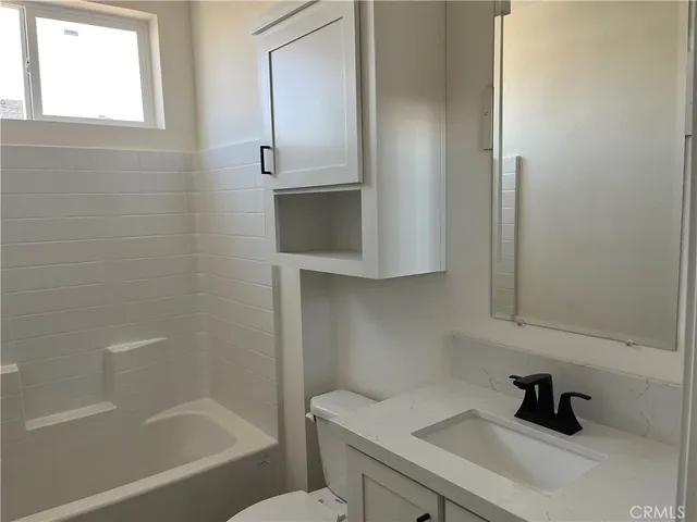 a bathroom with a toilet and a bathtub