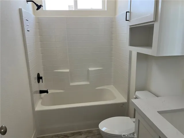 a bathroom with a sink a toilet and vanity