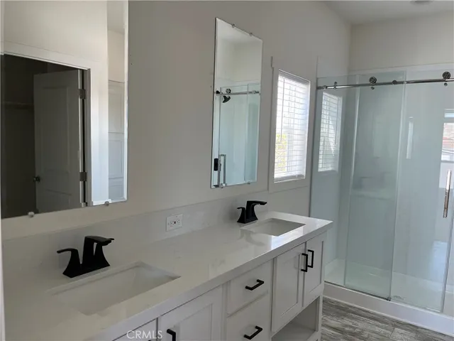 a bathroom with a sink a mirror and shower
