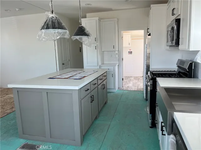 a kitchen with a sink stove and refrigerator