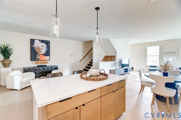 a kitchen with a sink a counter and chairs