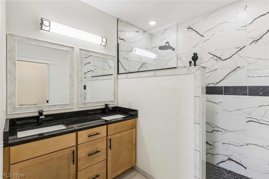 6535 North Ridge Road West Geneva, OH 44041 - Photo 31 of 48 Bathroom featuring a marble finish shower and double vanity