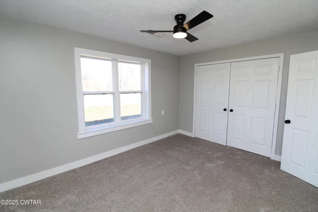 a view of room with a ceiling fan and window