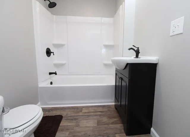 a bathroom with a sink a toilet and bathtub