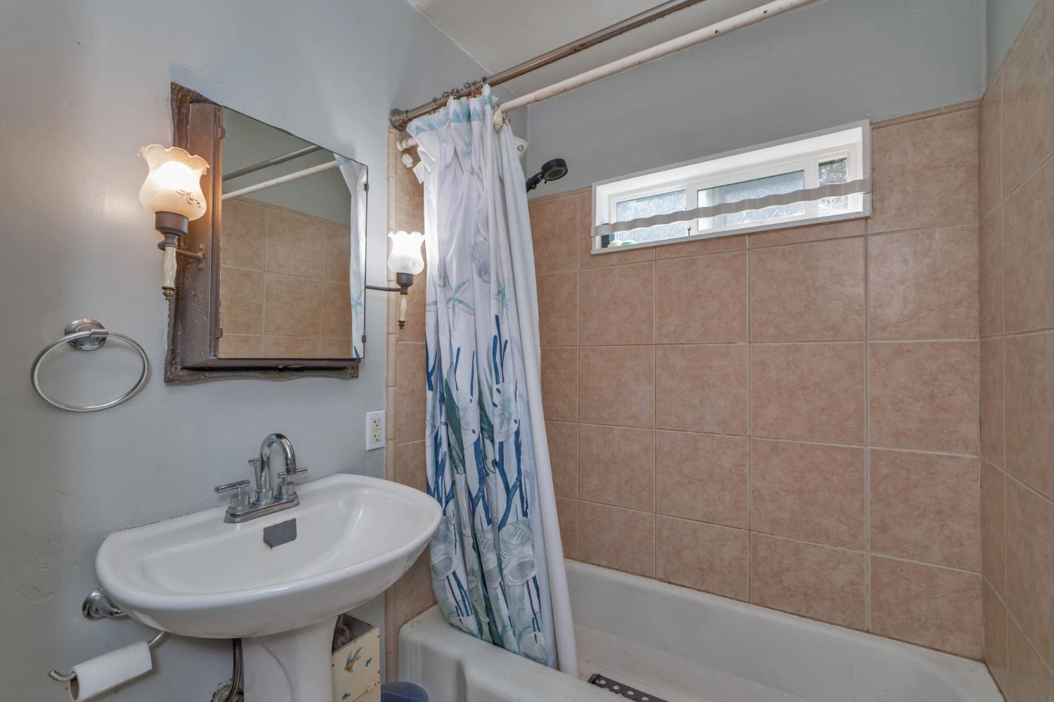 6929 Split Bend Road Pollock Pines, CA 95726 - Photo 26 of 38 a bathroom with a sink a mirror and a shower