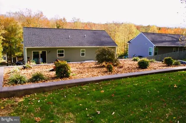 a front view of house with yard and trees