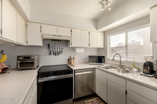 a kitchen with a sink and a stove top oven