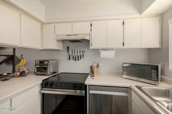 a kitchen with a refrigerator and cabinets