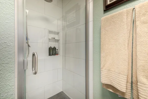 a bathroom with a granite countertop sink a toilet and shower
