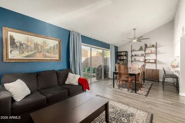 a living room with furniture a dining table and a bookshelf