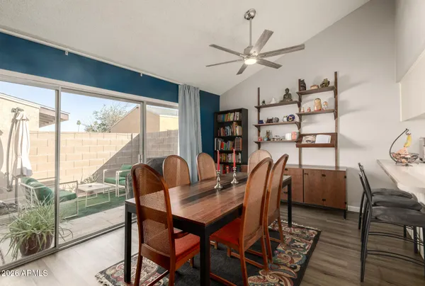 a dining room with furniture and wooden floor