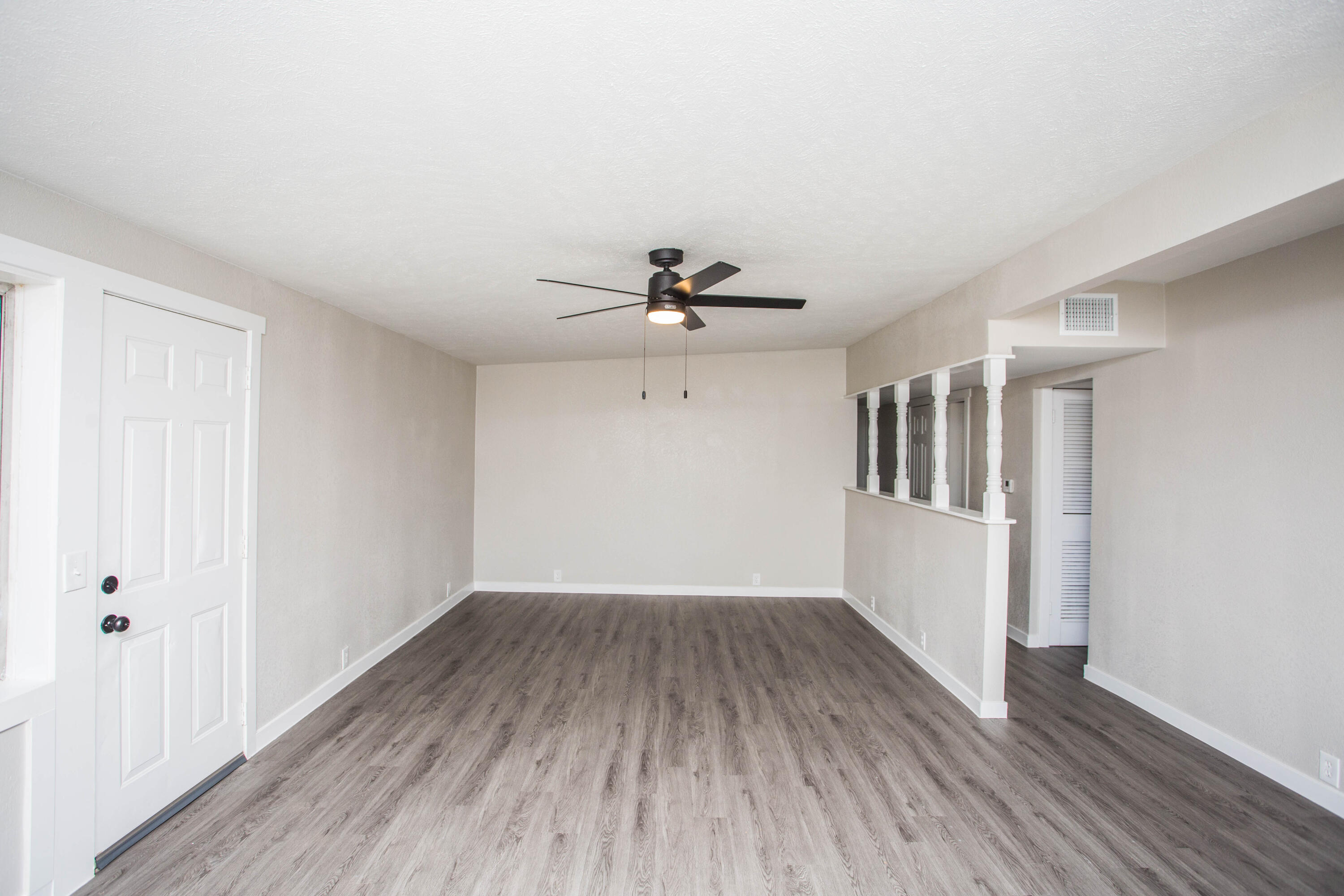2725 63rd Street Lubbock, TX 79413 - Photo 11 of 42 a view of a room with wooden floor and a ceiling fan