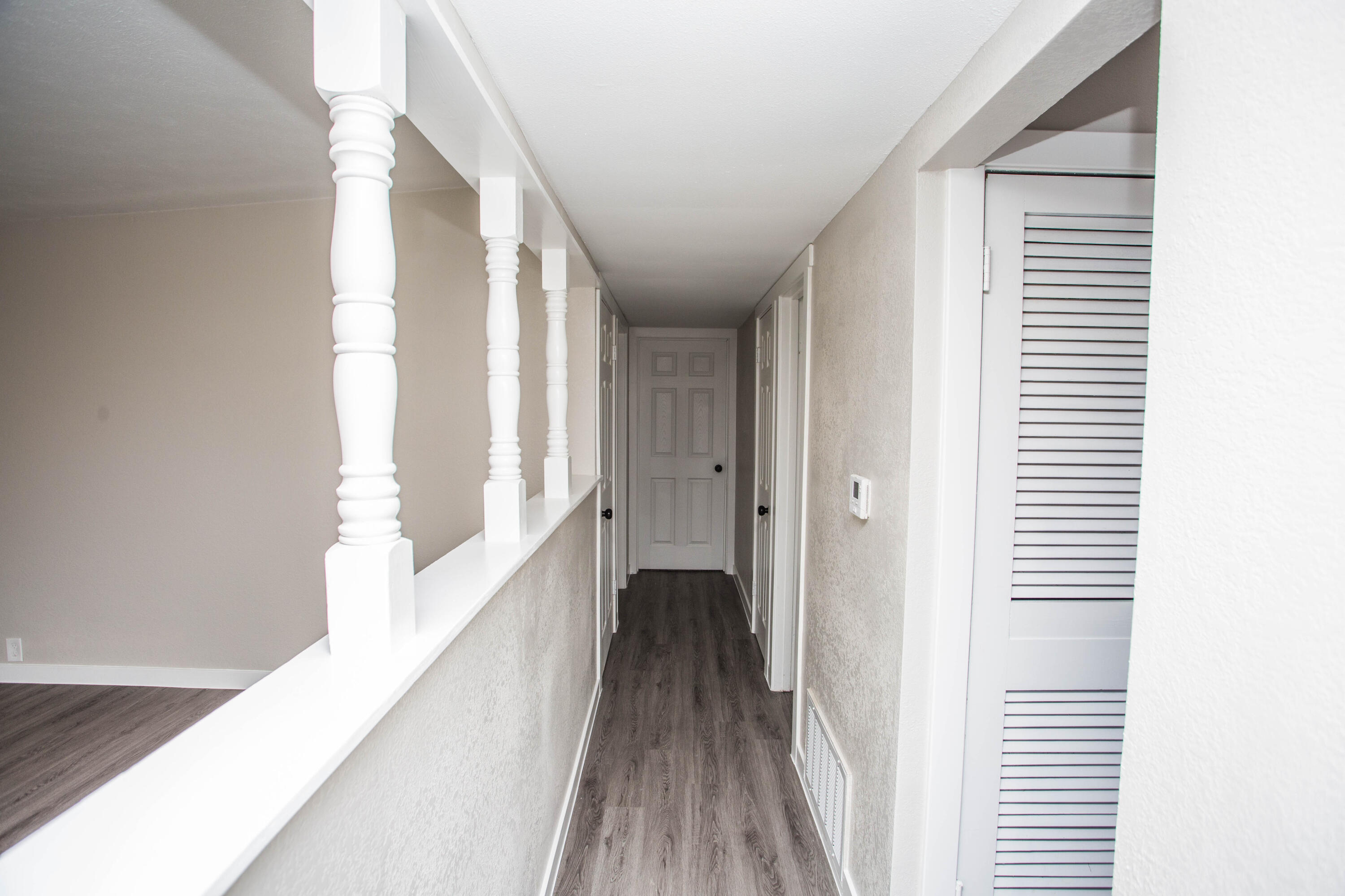 2725 63rd Street Lubbock, TX 79413 - Photo 13 of 42 a view of a hallway with wooden floor and staircase