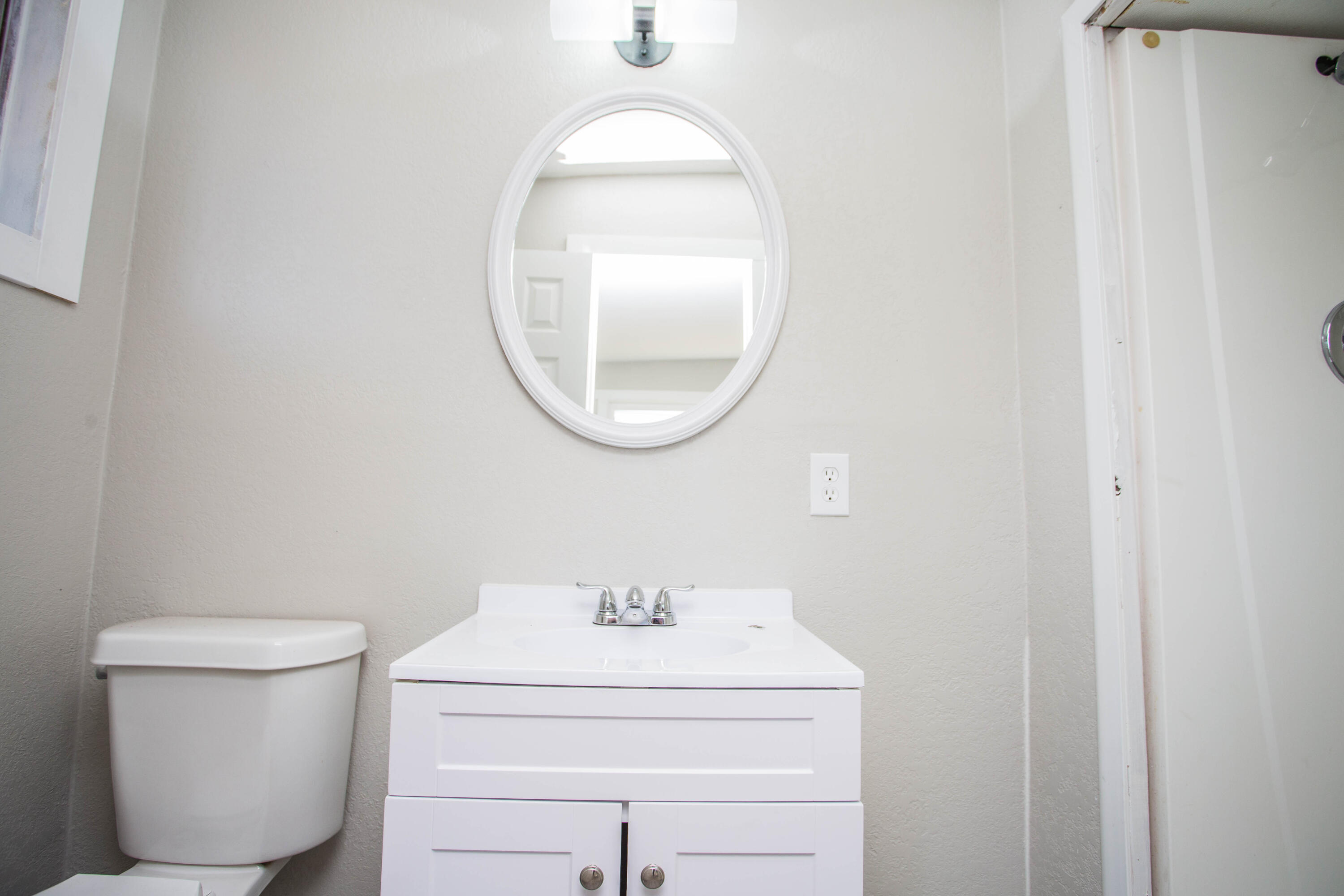 2725 63rd Street Lubbock, TX 79413 - Photo 23 of 42 a bathroom with a sink mirror and toilet