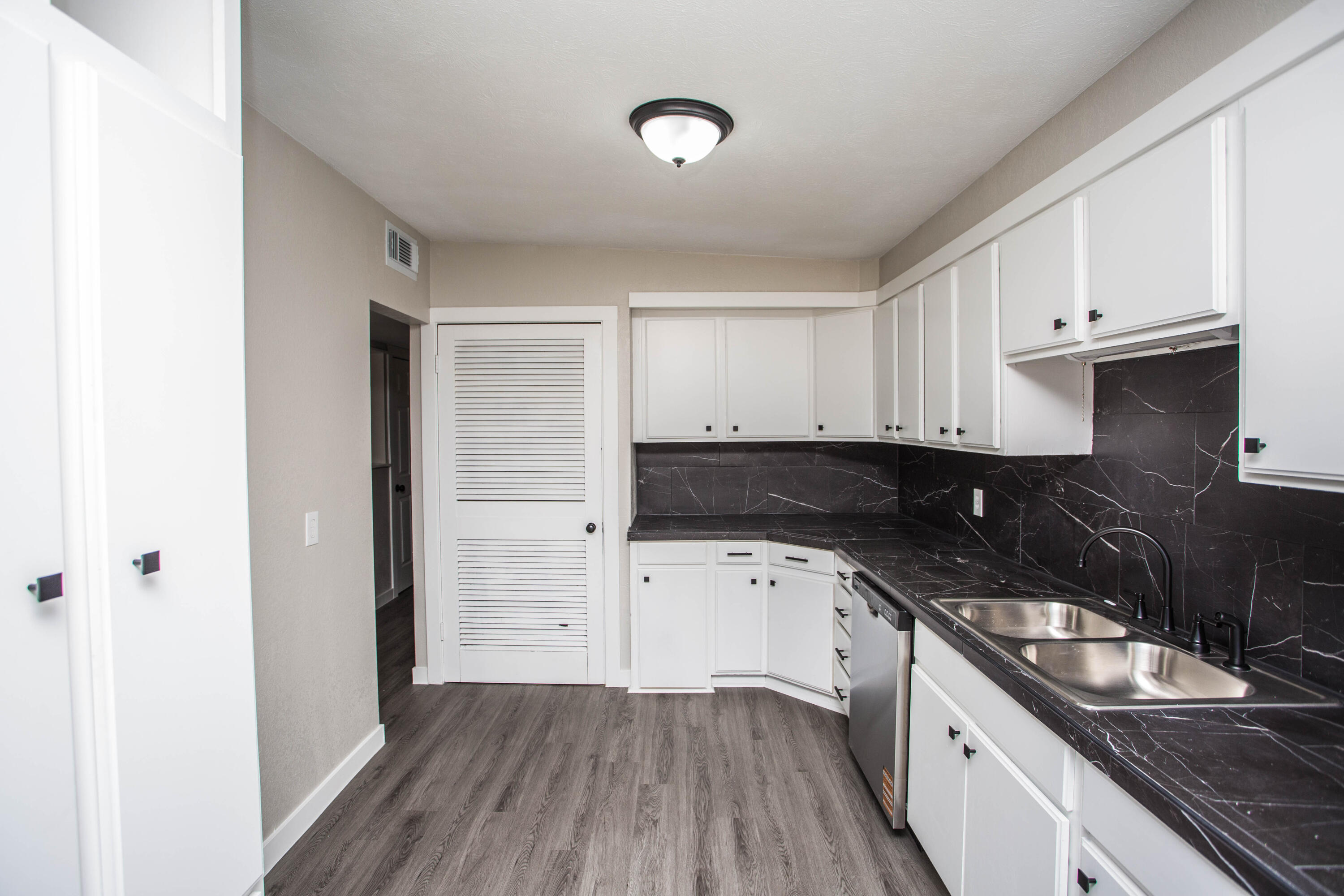 2725 63rd Street Lubbock, TX 79413 - Photo 5 of 42 a kitchen with a sink a stove and cabinets