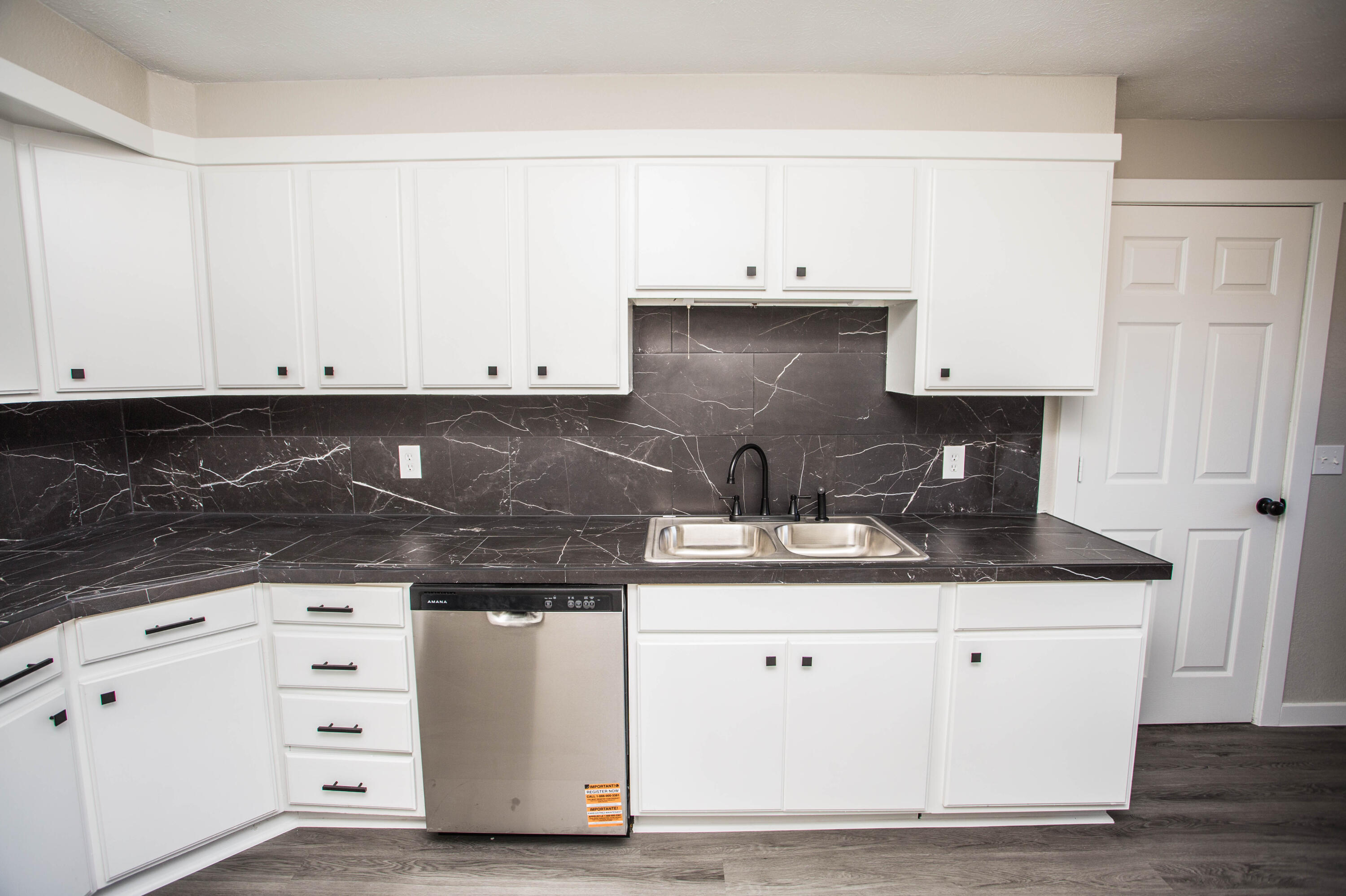 2725 63rd Street Lubbock, TX 79413 - Photo 6 of 42 a kitchen with granite countertop white cabinets and stainless steel appliances