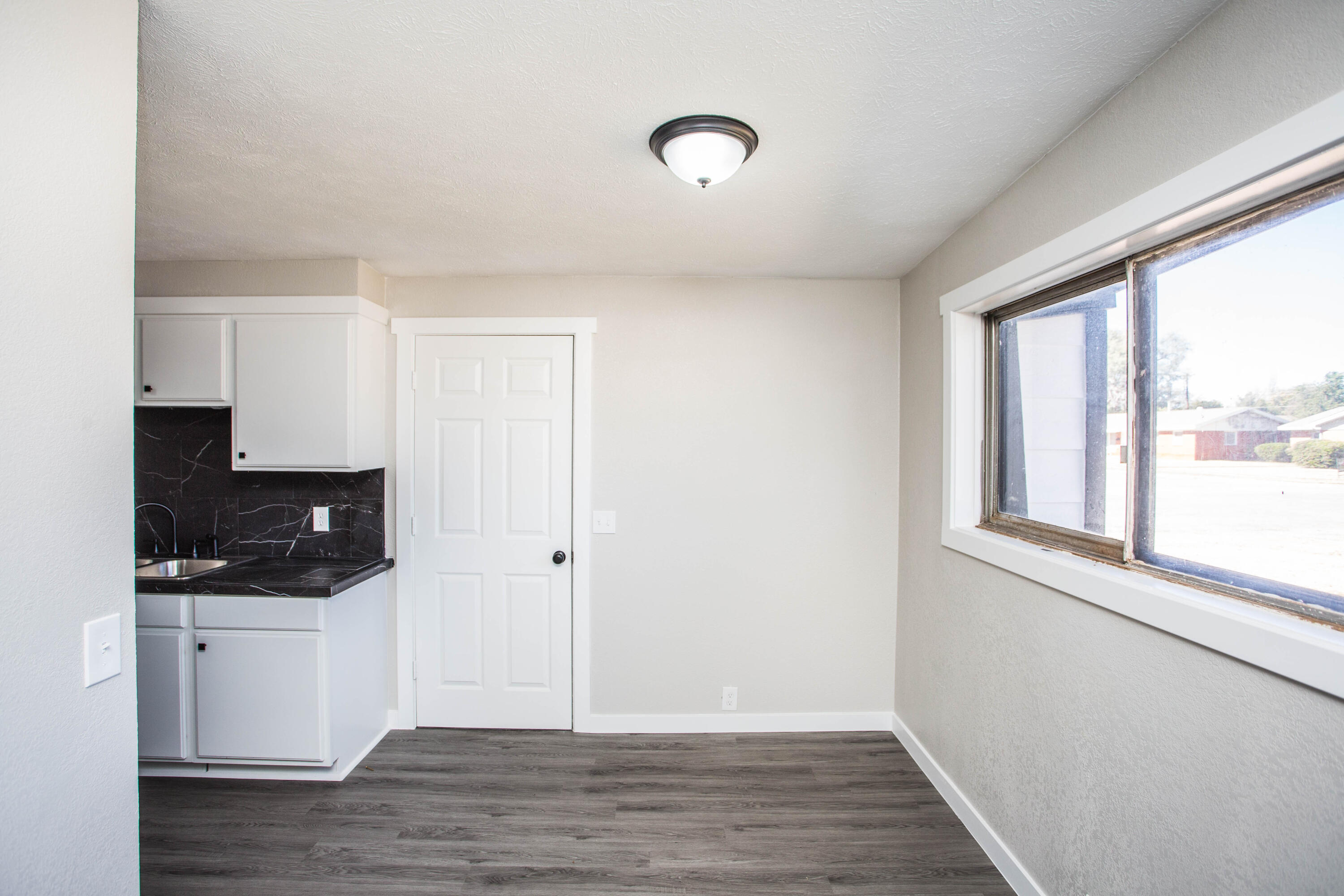 2725 63rd Street Lubbock, TX 79413 - Photo 8 of 42 a view of a kitchen with wooden floor and electronic appliances