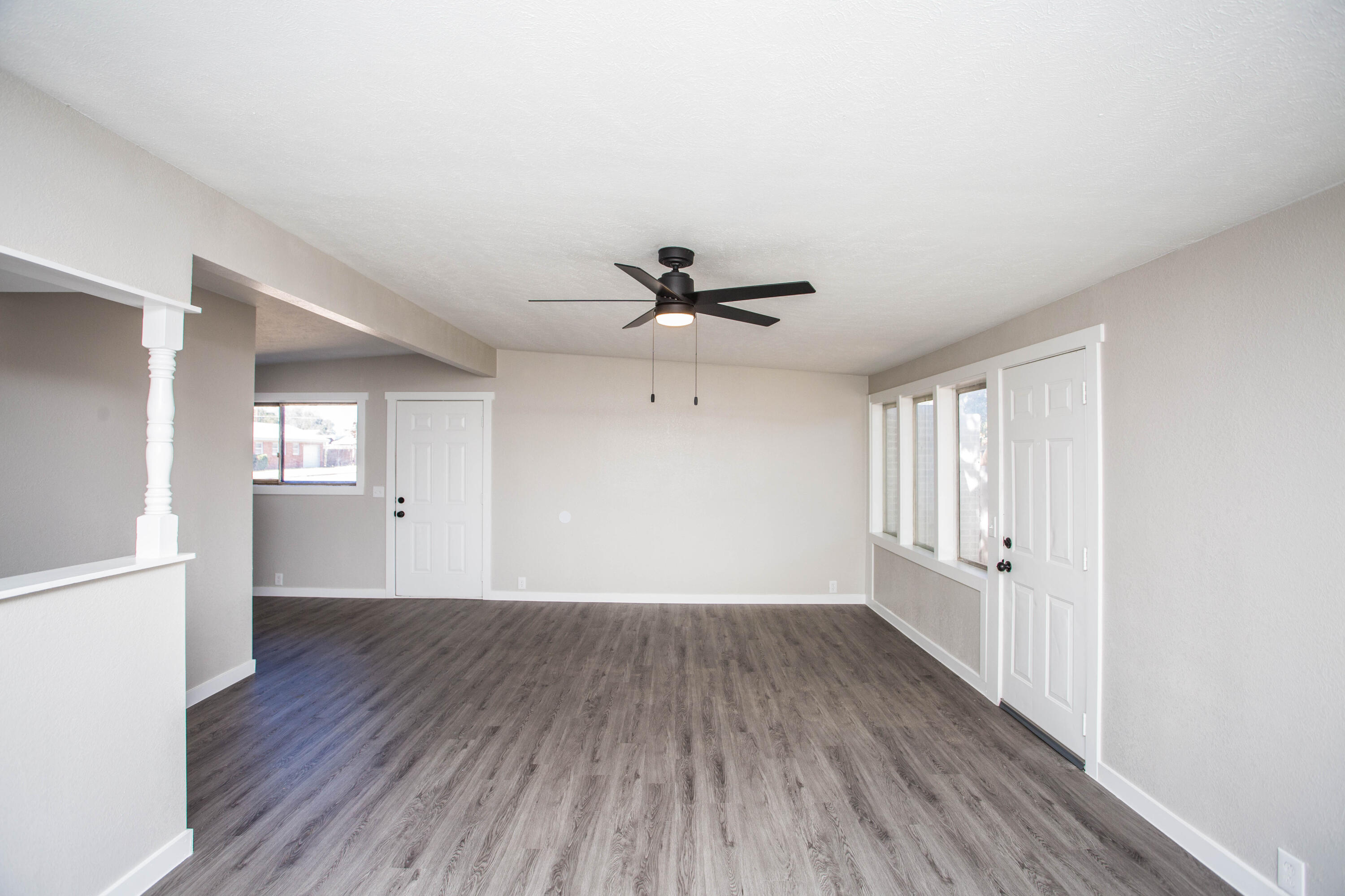 2725 63rd Street Lubbock, TX 79413 - Photo 9 of 42 a view of an empty room with a window and wooden floor