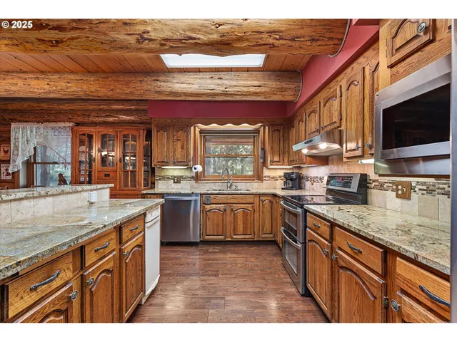 a view of a kitchen area with furniture and wooden floor