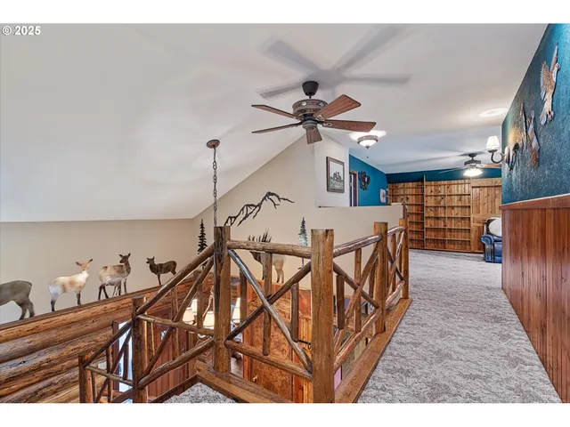 a bedroom with a bed a dresser with wooden floor