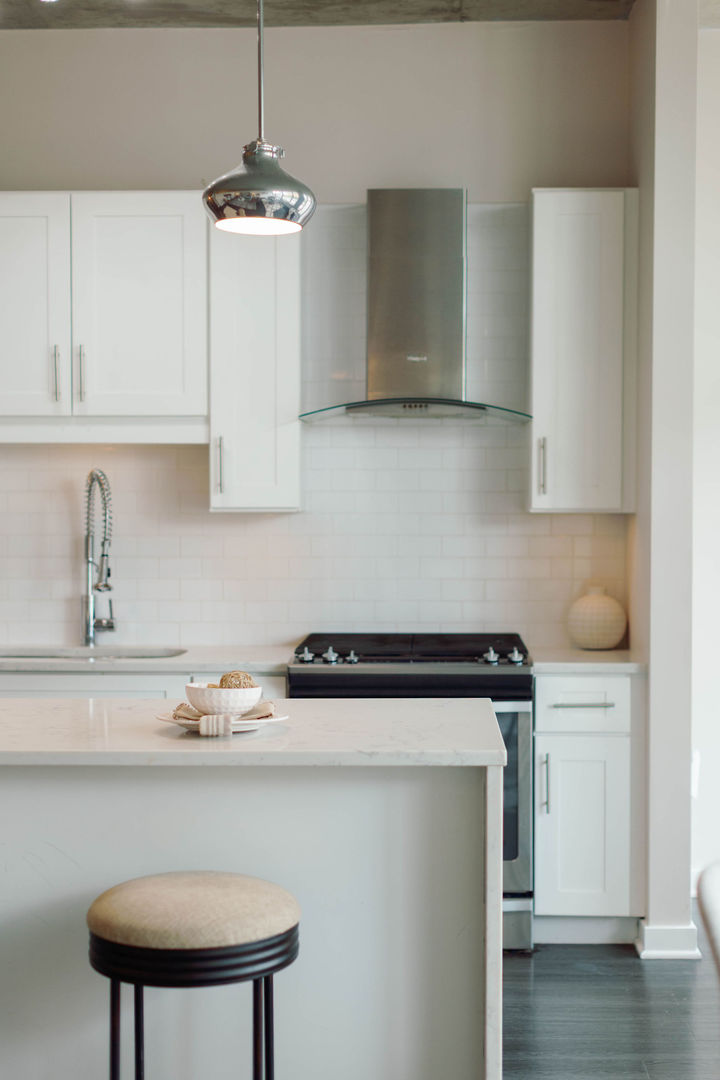 50 East 16th Street, Unit 402 Chicago, IL 60616 - Photo 15 of 33 a kitchen with stainless steel appliances a stove a sink and white cabinets with wooden floor