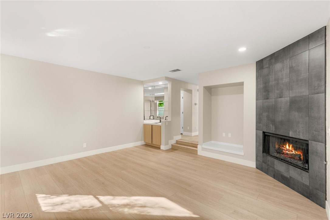 2104 Inverness Drive Henderson, NV 89074 - Photo 13 of 51 Unfurnished living room with light wood-type flooring, a tile fireplace, and recessed lighting