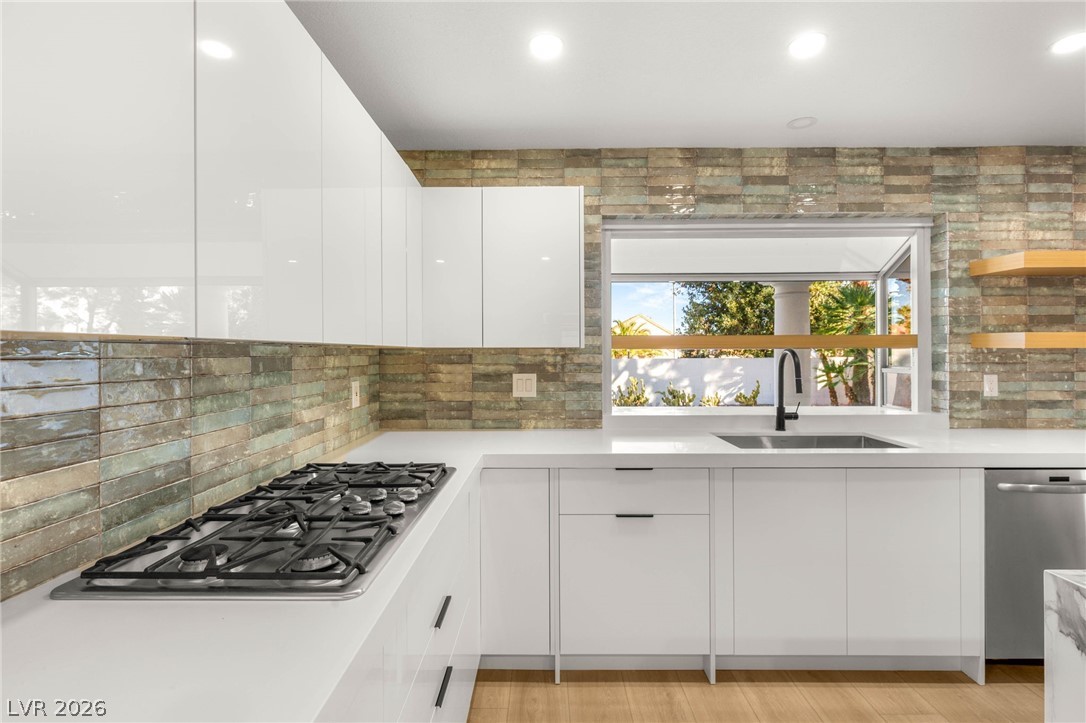 2104 Inverness Drive Henderson, NV 89074 - Photo 16 of 51 Kitchen featuring modern cabinets, white cabinets, stainless steel appliances, recessed lighting, and light stone countertops