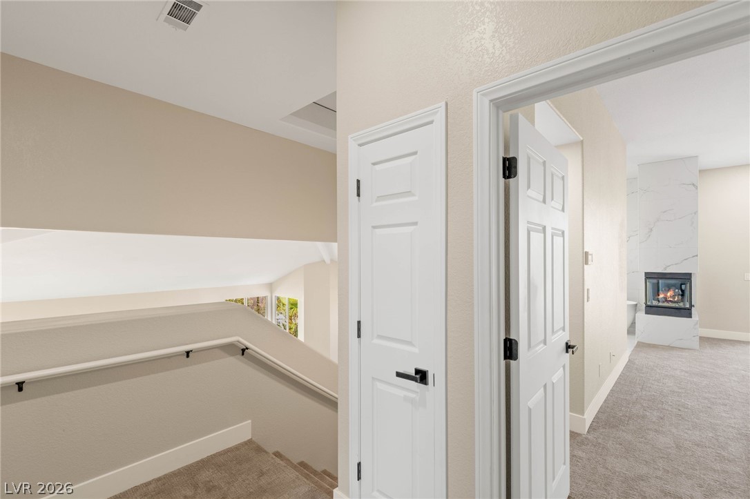 2104 Inverness Drive Henderson, NV 89074 - Photo 23 of 51 Hallway featuring light colored carpet and baseboards