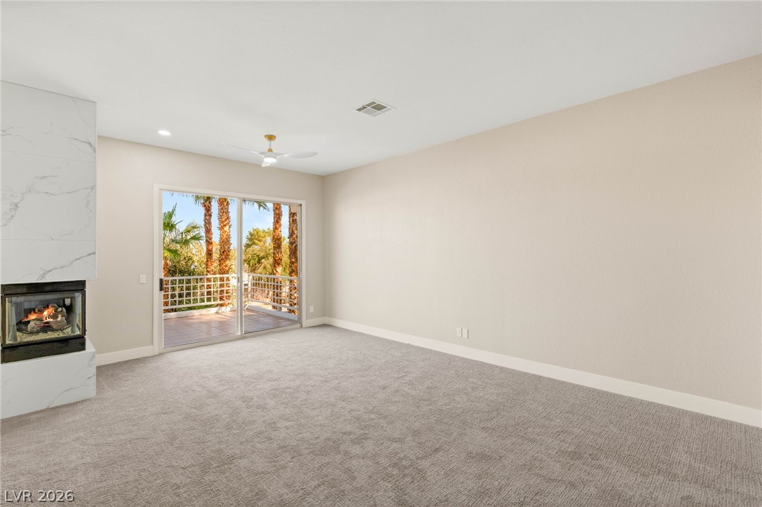 2104 Inverness Drive Henderson, NV 89074 - Photo 24 of 51 Unfurnished living room with a fireplace, carpet floors, recessed lighting, and ceiling fan
