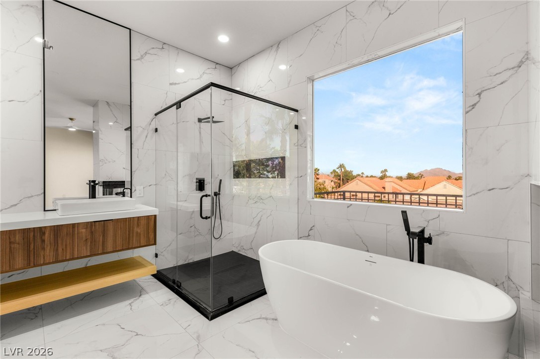 2104 Inverness Drive Henderson, NV 89074 - Photo 29 of 51 Bathroom featuring vanity, a marble finish shower, a soaking tub, light marble finish floors, and stone wall