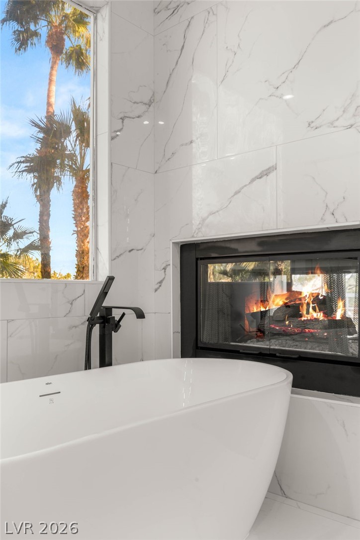 2104 Inverness Drive Henderson, NV 89074 - Photo 33 of 51 Bathroom view of a freestanding tub and a premium fireplace