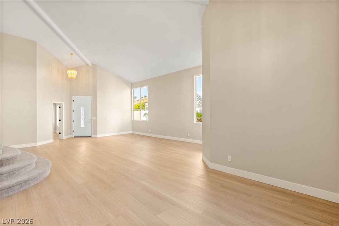 2104 Inverness Drive Henderson, NV 89074 - Photo 9 of 51 Unfurnished living room with high vaulted ceiling and light wood-style flooring