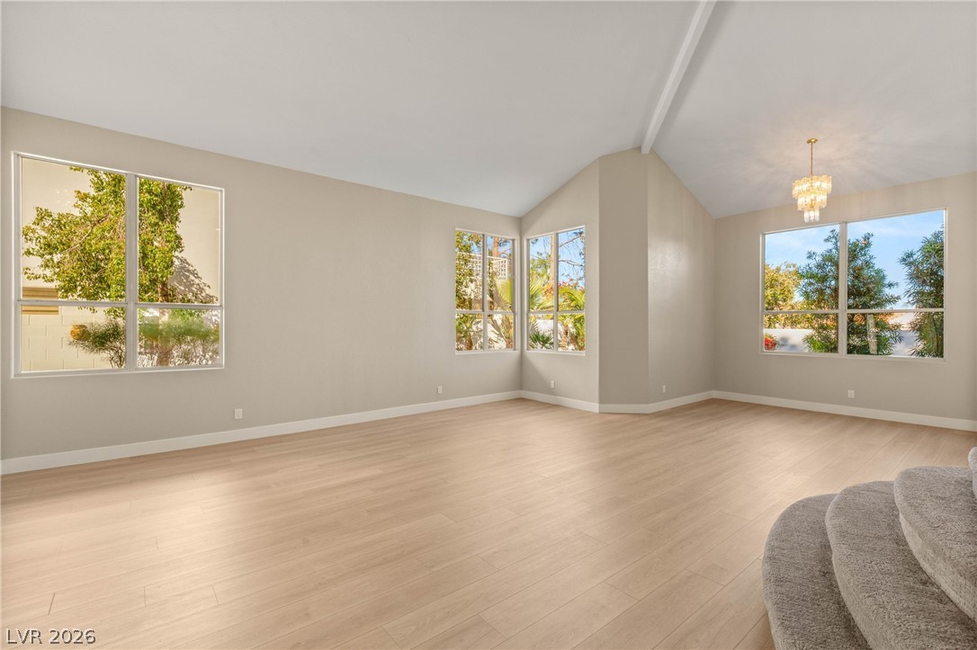 2104 Inverness Drive Henderson, NV 89074 - Photo 10 of 51 Unfurnished living room featuring light wood-style floors and a chandelier