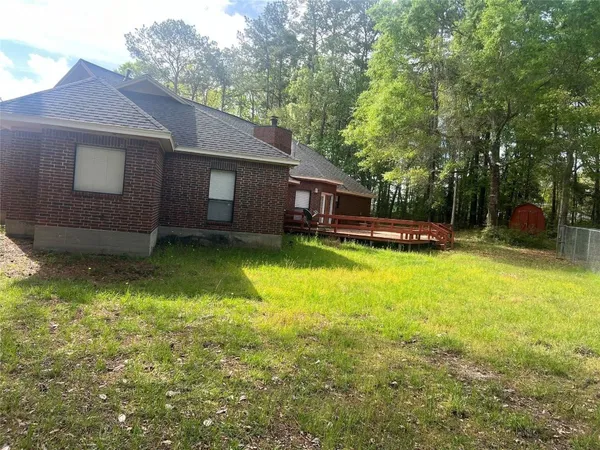 a view of a house with a yard balcony and swimming pool
