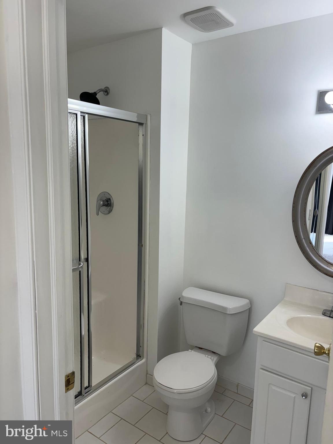 9228 Blue Grass Road, Unit 4 Philadelphia, PA 19114 - Photo 14 of 17 a white toilet sitting next to a bathroom sink