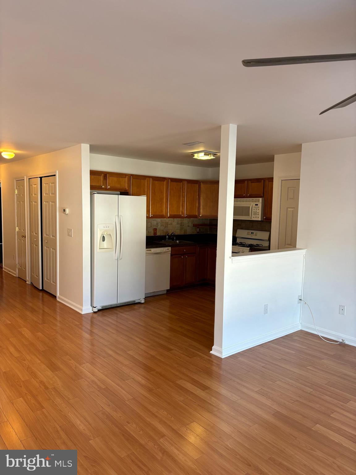 9228 Blue Grass Road, Unit 4 Philadelphia, PA 19114 - Photo 5 of 17 a view of a kitchen with wooden floor and a refrigerator