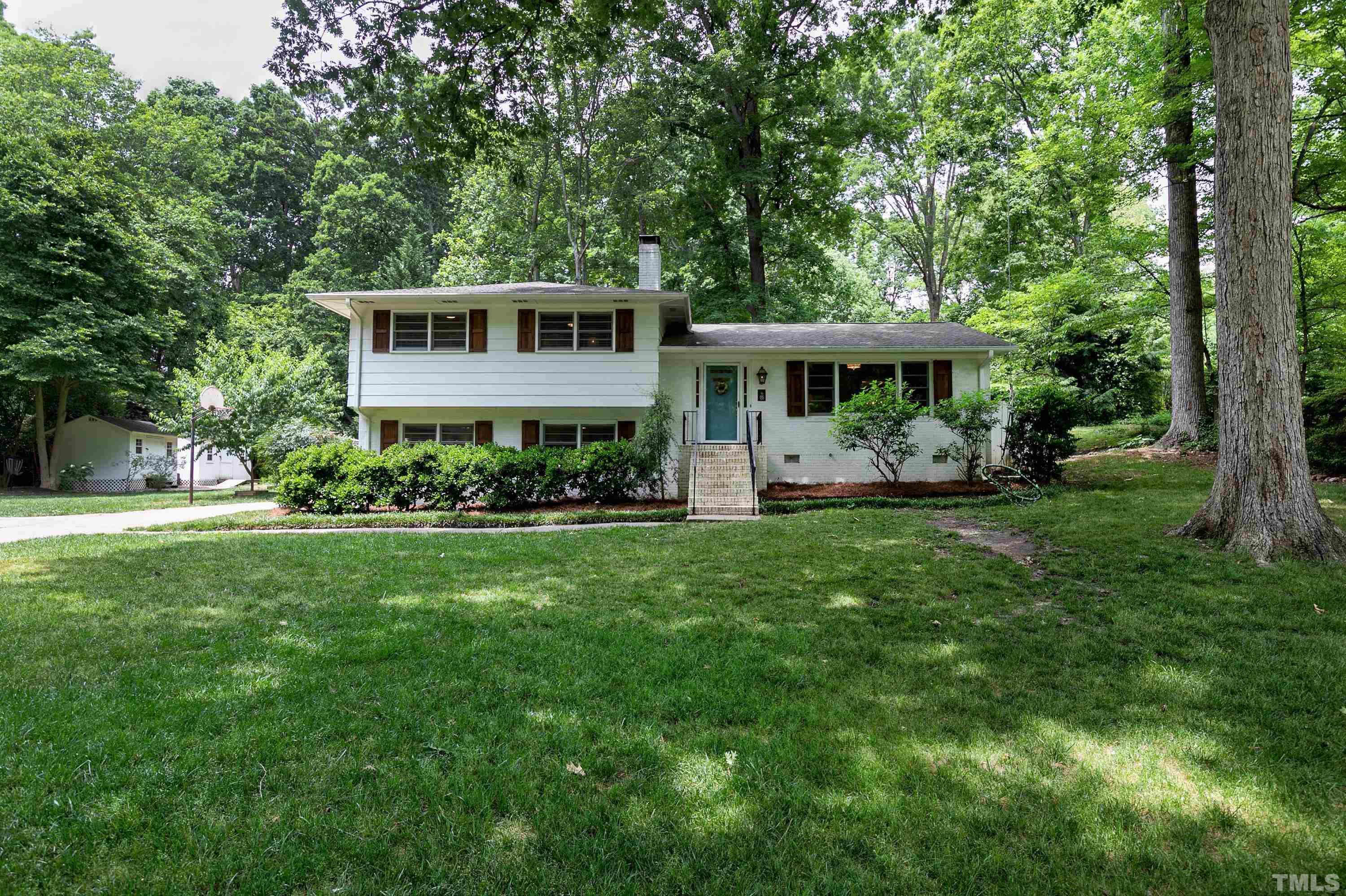 1300 Kingston Ridge Road Cary, NC 27511 - Photo 1 of 40 a front view of a house with a yard table and chairs