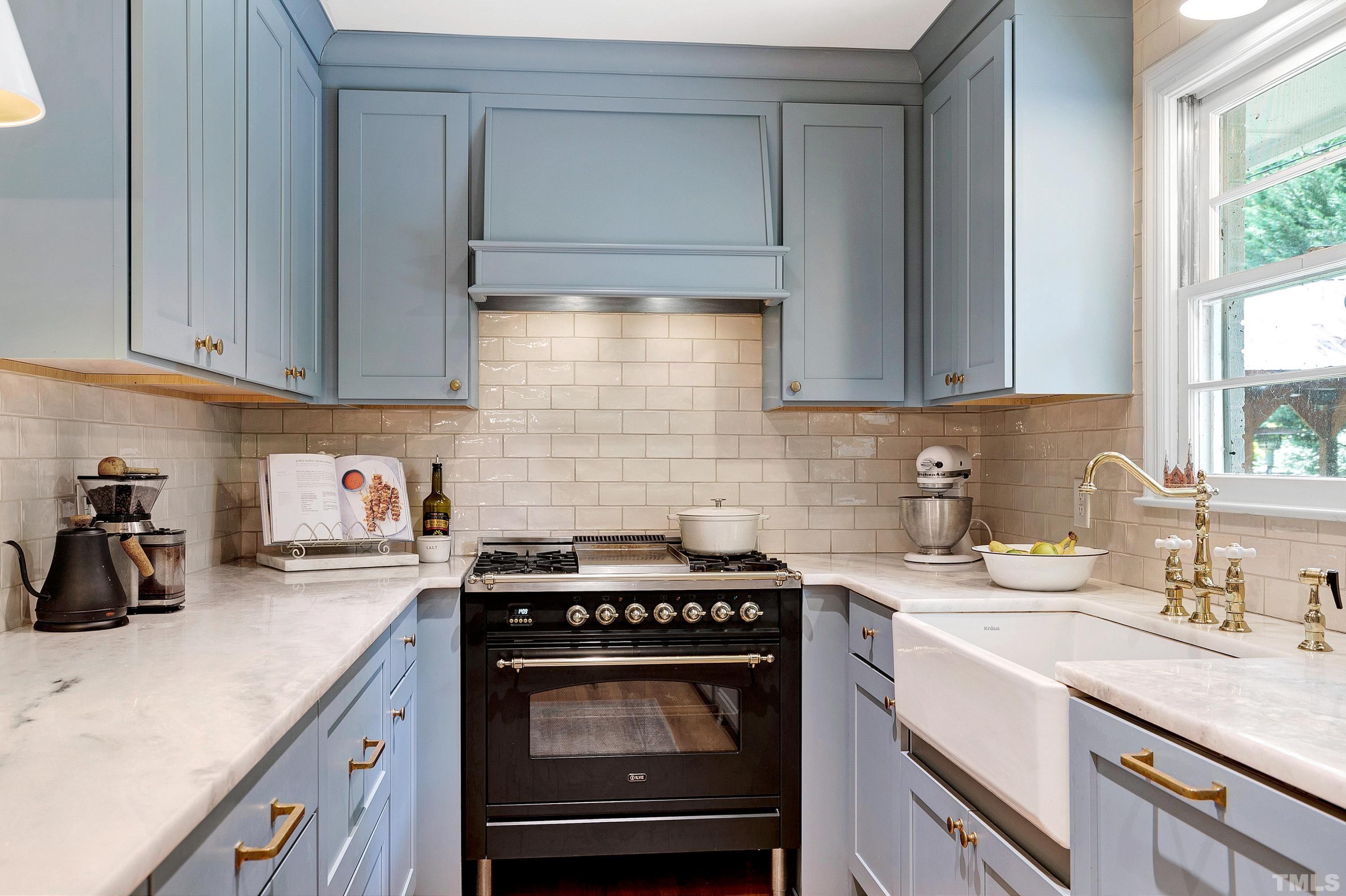 1300 Kingston Ridge Road Cary, NC 27511 - Photo 11 of 40 a kitchen with a stove a sink and cabinets