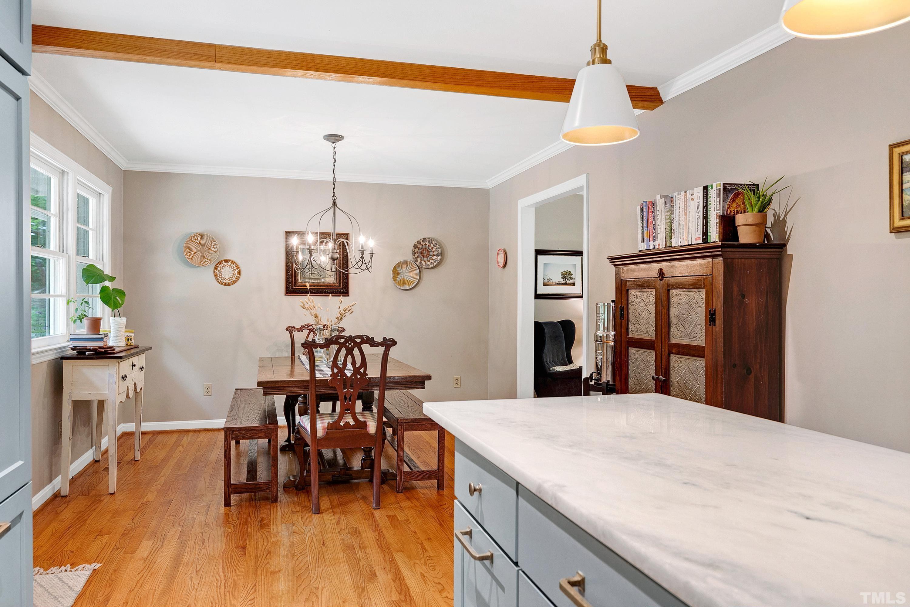 1300 Kingston Ridge Road Cary, NC 27511 - Photo 12 of 40 a view of a dining room with furniture and wooden floor