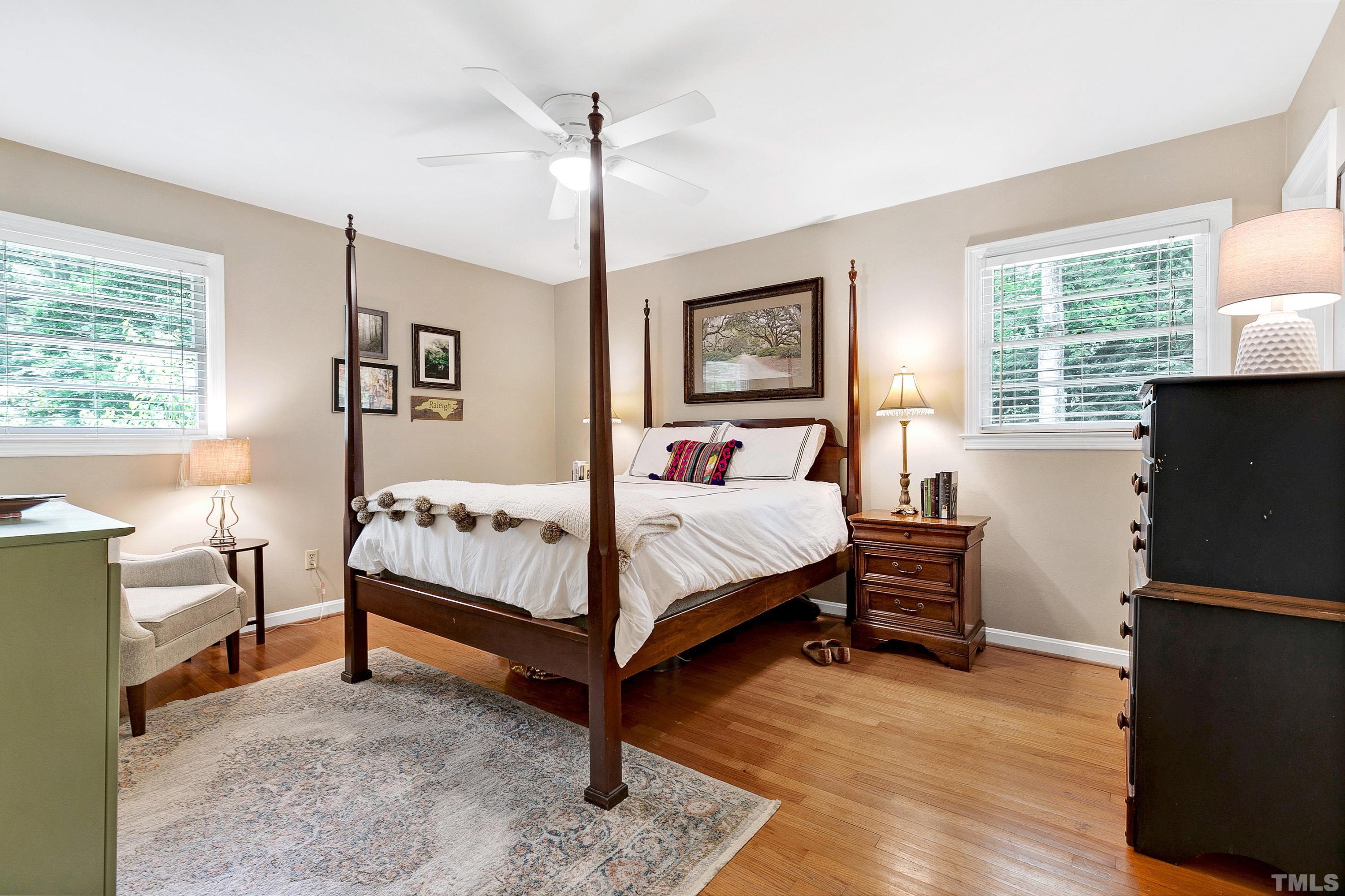 1300 Kingston Ridge Road Cary, NC 27511 - Photo 13 of 40 a bedroom with a bed and a flat tv screen on the dresser