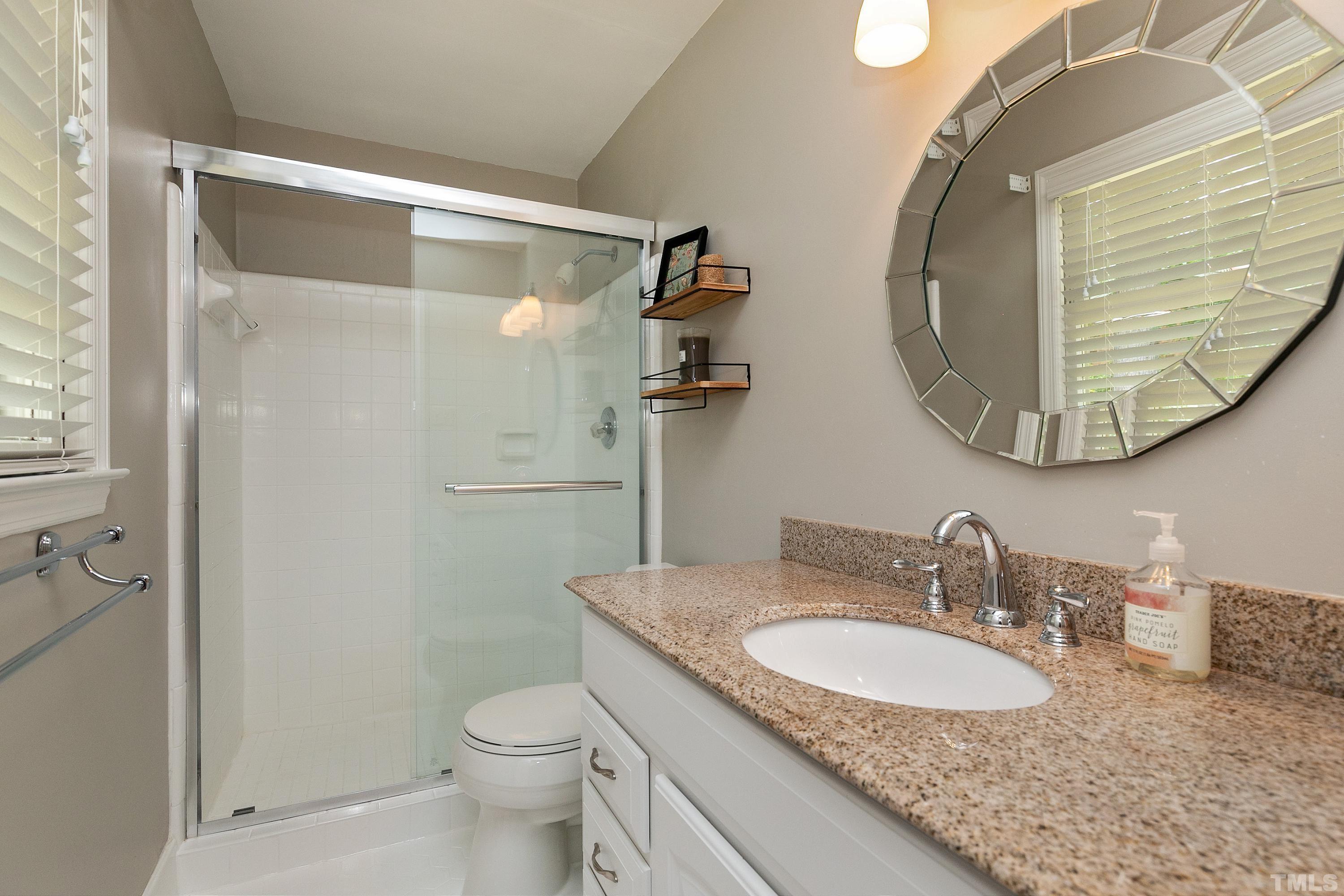 1300 Kingston Ridge Road Cary, NC 27511 - Photo 15 of 40 a bathroom with a granite countertop sink toilet and a mirror