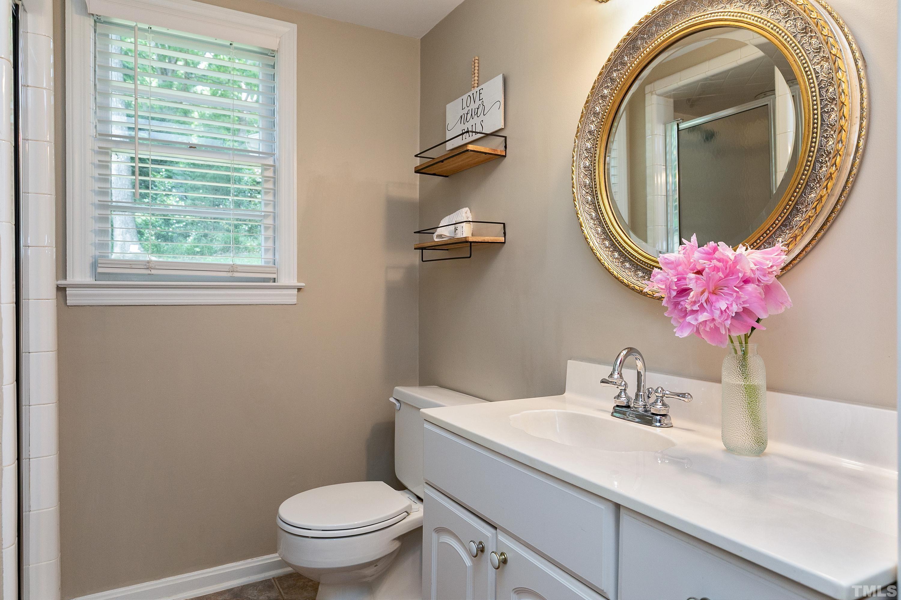 1300 Kingston Ridge Road Cary, NC 27511 - Photo 18 of 40 a bathroom with a toilet sink and mirror