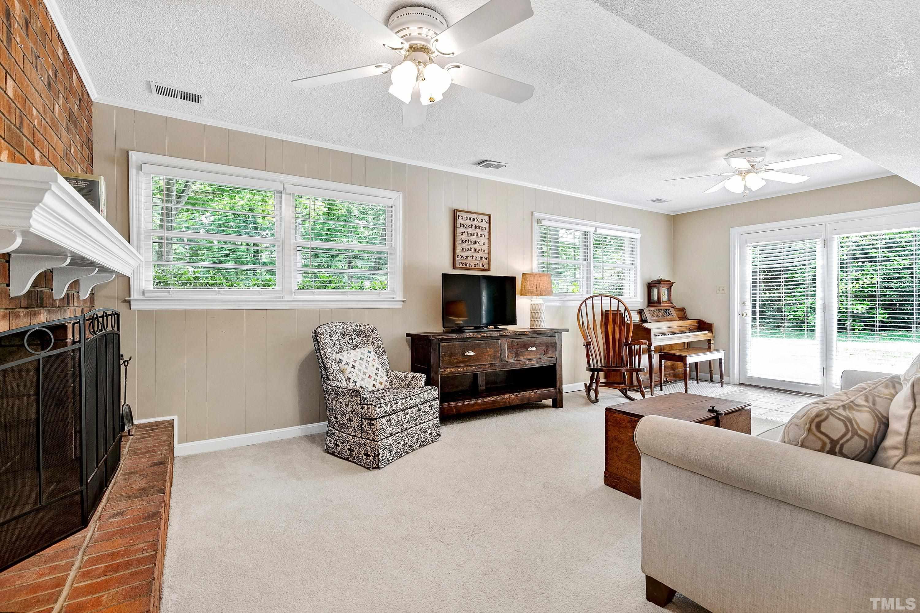 1300 Kingston Ridge Road Cary, NC 27511 - Photo 19 of 40 a living room with furniture flat screen tv and a fireplace