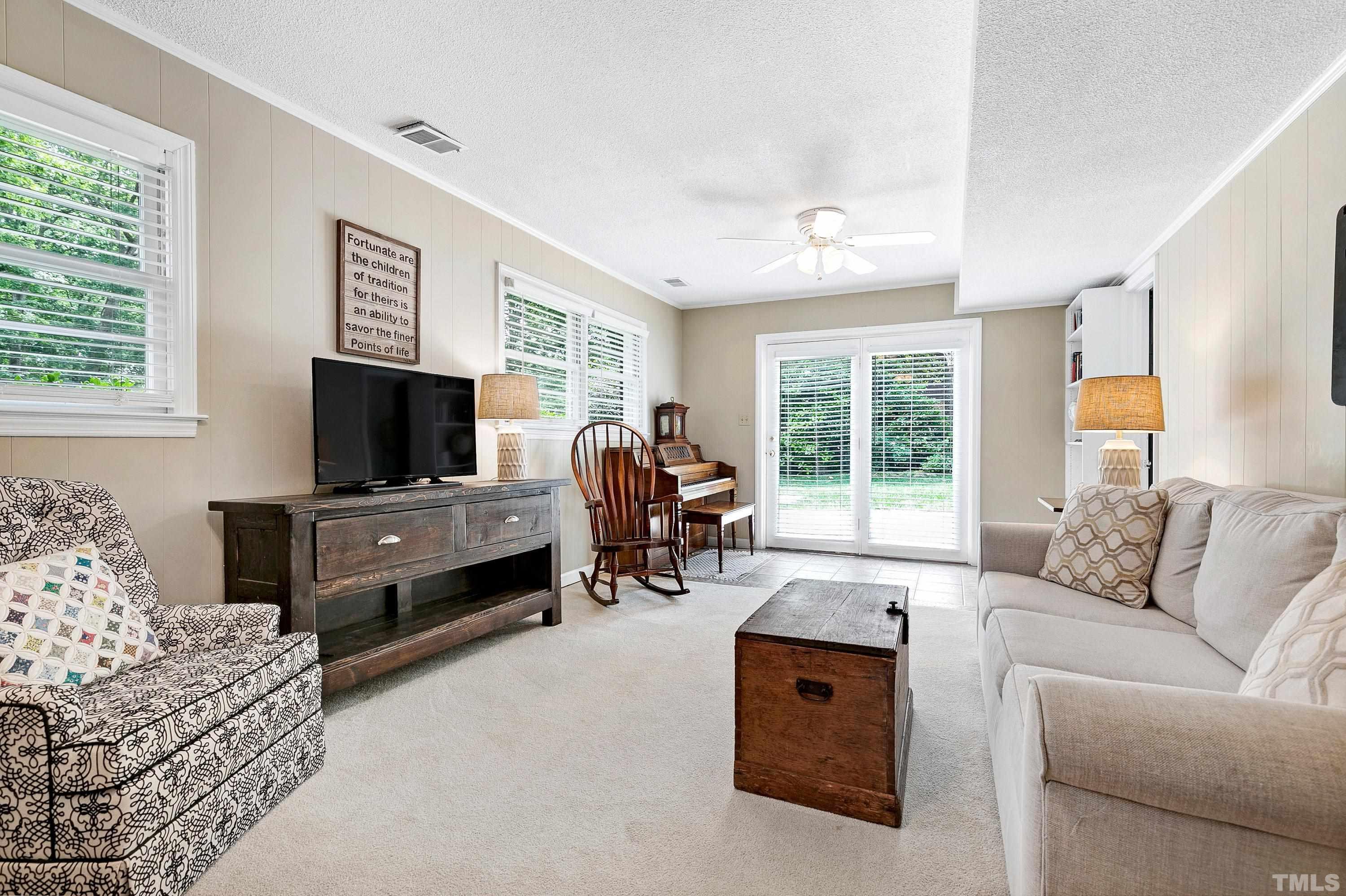 1300 Kingston Ridge Road Cary, NC 27511 - Photo 20 of 40 a living room with furniture and a flat screen tv