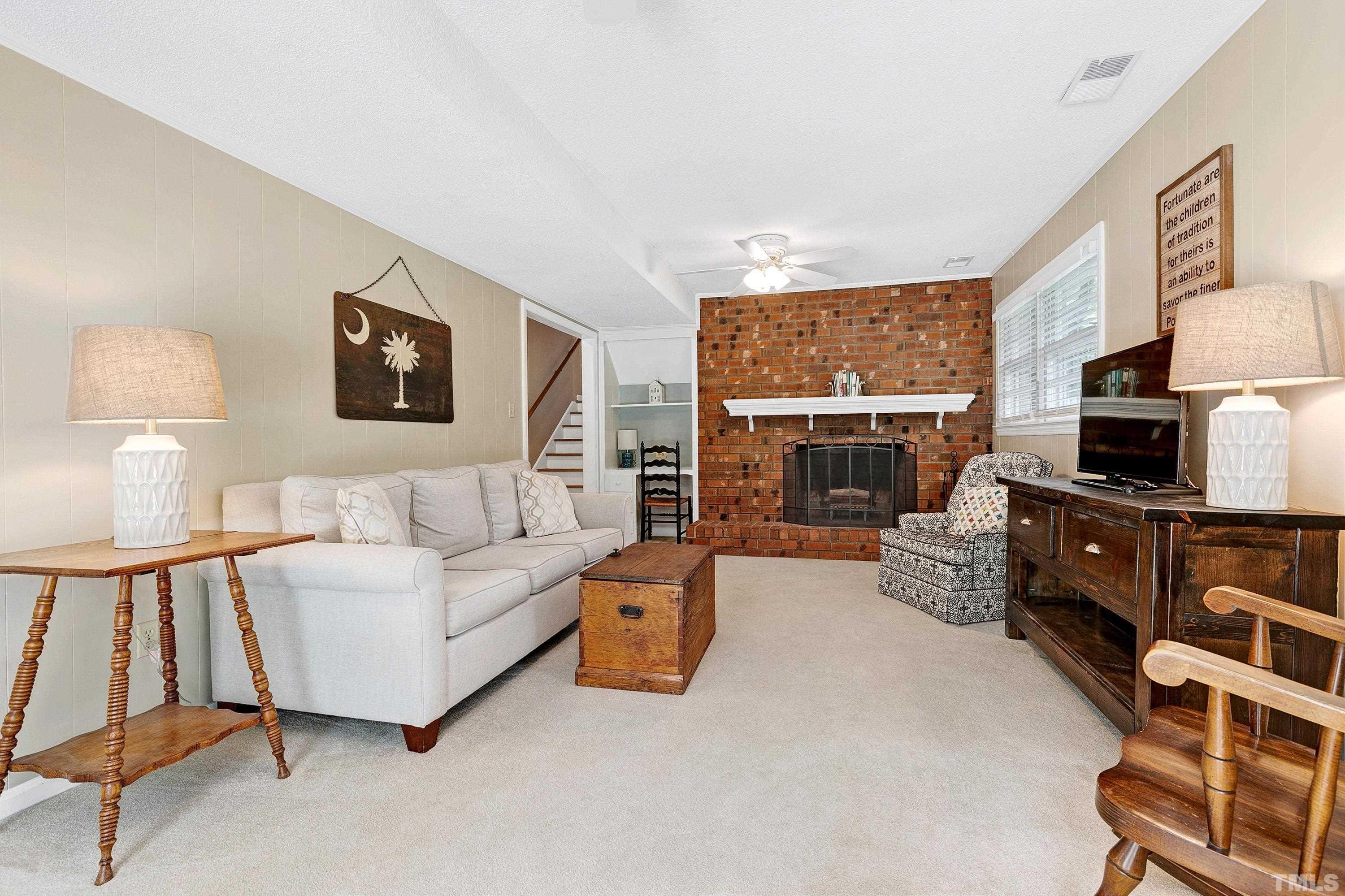 1300 Kingston Ridge Road Cary, NC 27511 - Photo 21 of 40 a living room with furniture a flat screen tv and a fireplace