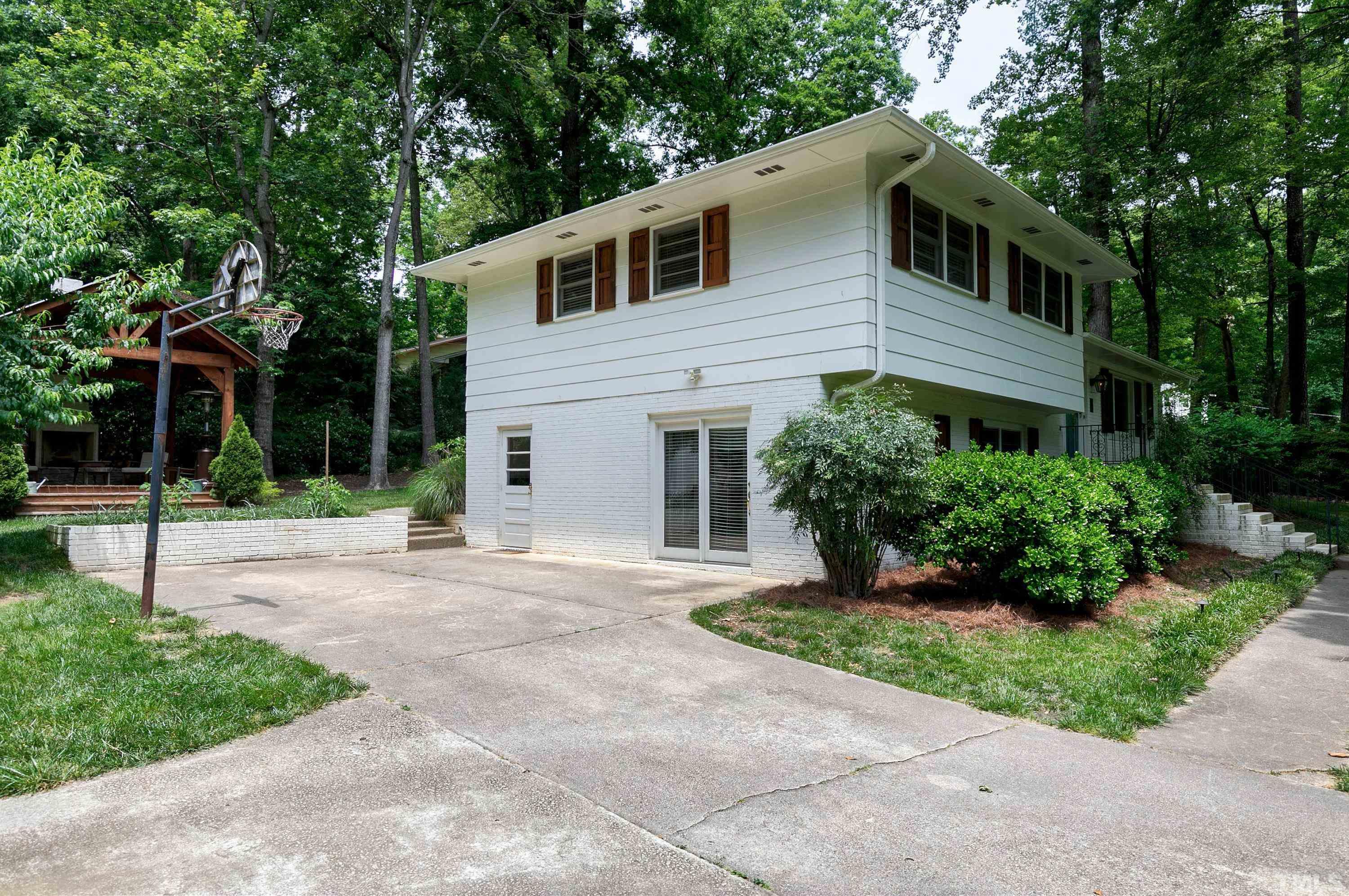1300 Kingston Ridge Road Cary, NC 27511 - Photo 27 of 40 a front view of a house with a yard and potted plants